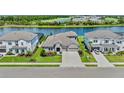 Aerial view of a beautiful home next to a lake and golf course surrounded by lush greenery at 4430 Pond Brook Ct, Bradenton, FL 34211