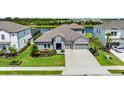 Charming single-Gathering home featuring a stone facade, well-manicured lawn, and a two-car garage at 4430 Pond Brook Ct, Bradenton, FL 34211