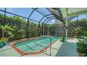 Screened-in pool area, featuring a small pool and surrounding greenery, creating a private outdoor space at 4612 4Th E Ave, Bradenton, FL 34208