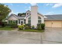 Charming home featuring arched windows, a well-manicured lawn, and a two-car garage at 4629 Whirlaway Dr # B, Sarasota, FL 34233