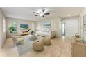 Bright living room with stylish furnishings, neutral colors, and wood-look flooring for a modern aesthetic at 5109 28Th W St, Bradenton, FL 34207