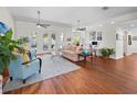 Spacious living room with hardwood floors, ceiling fans, and abundant natural light, offering a welcoming atmosphere at 5110 19Th W Ave, Bradenton, FL 34209