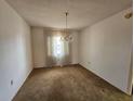 Dining room with outdated carpet and a vintage chandelier at 5114 36Th Avenue W Dr, Bradenton, FL 34209