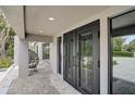 Close-up of modern double front doors, showcasing the home's stylish entrance and inviting curb appeal at 512 Treasure Boat Way, Sarasota, FL 34242