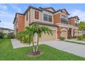 Beautiful two-story townhome features a two car garage, walkway, and landscaping at 5191 78Th St E Cir, Bradenton, FL 34203