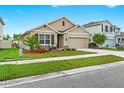 Charming single-Gathering home featuring a well-manicured lawn, neutral exterior, and a two-car garage at 5659 Woodland Sage Dr, Sarasota, FL 34238