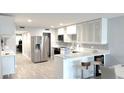 Bright kitchen features stainless steel appliances, updated cabinets, and quartz countertops at 6400 46Th N Ave # 113, Kenneth City, FL 33709