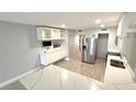 This kitchen is equipped with new appliances and stylish cabinetry at 6400 46Th N Ave # 113, Kenneth City, FL 33709
