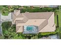 Overhead drone shot of the home's layout, screened in pool, and tile roof at 7507 Ascot Ct, Bradenton, FL 34201