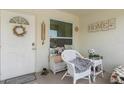 Cozy front porch with inviting seating, perfect for relaxing and enjoying the neighborhood ambiance at 8638 Bessemer Ave, North Port, FL 34287