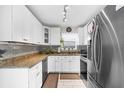 Beautiful kitchen with stainless steel appliances, granite counters, and ample cabinet space at 8638 Bessemer Ave, North Port, FL 34287