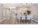 Open-concept dining room with modern decor, wood floors, and views of the foyer at 8640 Stone Harbour Loop, Bradenton, FL 34212