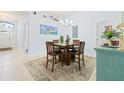 Open dining room showcasing wooden table and chairs, complemented by a turquoise accent piece at 9229 52Nd E Ave, Palmetto, FL 34221