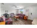 Comfortable living room with wood floors and a window offering pleasant views of the neighborhood at 928 Pineland Ave, Venice, FL 34285