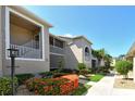 Inviting condo exterior with landscaped walkway, beautiful plants, and serene curb appeal at 9540 High Gate Dr # 1422, Sarasota, FL 34238