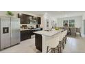 Modern kitchen with stainless steel appliances, granite countertops and dining area at 10820 Gentle Current Way, Parrish, FL 34219