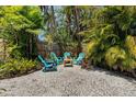Charming backyard with gravel, lush greenery, and comfortable outdoor seating at 139 Adair Ave, Sarasota, FL 34243