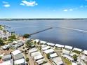 Stunning aerial view of a waterfront neighborhood with a long pier extending into the water at 14 Braden Castle Dr, Bradenton, FL 34208