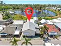 An aerial view shows the property's location near a beautiful pond and lush greenery at 14 Braden Castle Dr, Bradenton, FL 34208