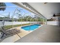 Inviting screened-in pool area with a spacious patio, perfect for outdoor relaxation and entertaining at 16834 Toledo Blade Blvd, Port Charlotte, FL 33954