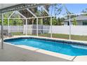 Sparkling pool with a screened-in enclosure and backyard views at 16834 Toledo Blade Blvd, Port Charlotte, FL 33954