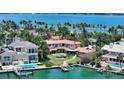 Gorgeous backyard featuring a waterfront with a private dock, a patio, and a beautifully landscaped lawn at 203 Robin Dr, Sarasota, FL 34236