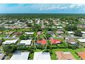 Overhead view of the property within a verdant neighborhood, revealing a screened-in pool area at 216 Matisse Cir, Nokomis, FL 34275