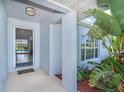 Inviting front entrance with manicured plants and a peek into the home's bright interior at 217 Mariner Ln, Rotonda West, FL 33947