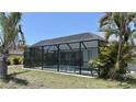 Inviting screened-in pool area perfect for relaxation and entertainment, surrounded by tropical landscaping at 217 Mariner Ln, Rotonda West, FL 33947