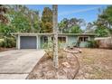 Charming single-story home with a lush landscaped yard, painted in a muted color at 2212 Vinson Ave, Sarasota, FL 34232