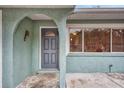 Close-up of the front door with an arched alcove and nearby windows at 2212 Vinson Ave, Sarasota, FL 34232