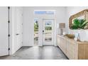 Bright entryway with modern decor, a stylish console table with decorative items, and a clear view of the landscaped front yard at 2314 Floyd St, Sarasota, FL 34239