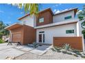 Stylish contemporary home featuring a clean exterior with wood accents, landscaped front yard, and a modern design at 2314 Floyd St, Sarasota, FL 34239