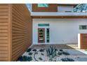 Modern home featuring a contemporary glass front door, low maintenance gravel landscaping with succulent accents, and clean lines at 2314 Floyd St, Sarasota, FL 34239