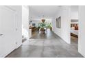 Open-concept hallway leading to the dining, living, and main bedroom areas, with bright, neutral walls and tile floors at 2314 Floyd St, Sarasota, FL 34239