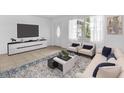 Modern living room with neutral furniture, tile flooring, and ample natural light creating a comfortable atmosphere at 3205 33Rd Street W Ct, Bradenton, FL 34205