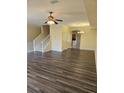 An inviting living room with wood flooring, a ceiling fan, and plenty of natural light and access to the dining area at 3409 10Th W Ln, Palmetto, FL 34221