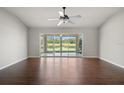Bright living room featuring hardwood floors, a ceiling fan, and expansive sliding glass doors with a view at 3415 68Th Street E Cir, Palmetto, FL 34221