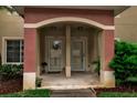 Close-up of the townhouse entrance, featuring unit doors, outdoor lighting and covered entryway at 3707 45Th W Ter # 104, Bradenton, FL 34210