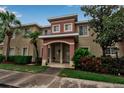Townhouse featuring well-maintained landscaping, an appealing archway entrance, and a neutral color scheme at 3707 45Th W Ter # 104, Bradenton, FL 34210