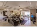 Spacious living room with elegant tray ceiling, neutral decor and open floor plan at 3835 W Price Blvd, North Port, FL 34286