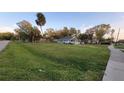 Quaint single-story home with a spacious front yard, surrounded by mature trees at 4223 Sawyer Rd, Sarasota, FL 34233