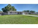 Well-maintained single-story home with green lawn and landscaping, showcasing curb appeal at 4611 Spahn St, Sarasota, FL 34232
