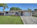 Inviting single-story home with a freshly landscaped yard and a cozy seating area near the entrance at 4611 Spahn St, Sarasota, FL 34232