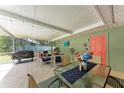 Covered patio with grill, string lights, a ceiling fan, and outdoor dining at 4907 18Th W Ave, Bradenton, FL 34209