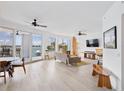 Bright and airy living room with views of the water, light wood flooring and coastal decor at 516 Tamiami S Trl # 306, Nokomis, FL 34275