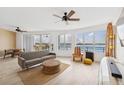 Inviting living room with waterfront views, ceiling fan, and comfortable seating at 516 Tamiami S Trl # 306, Nokomis, FL 34275