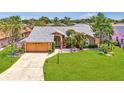 Aerial view showcasing a beautiful single-story home with a spacious yard and a well-manicured lawn at 5742 39Th Street E Cir, Bradenton, FL 34203