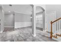 Beautiful dining area featuring elegant archways, tile flooring, and decorative wainscoting at 6125 Anise Dr, Sarasota, FL 34238