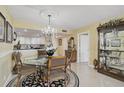 Bright dining room with modern chandelier and views into the kitchen at 6372 Palma Del Mar S Blvd # 503, St Petersburg, FL 33715